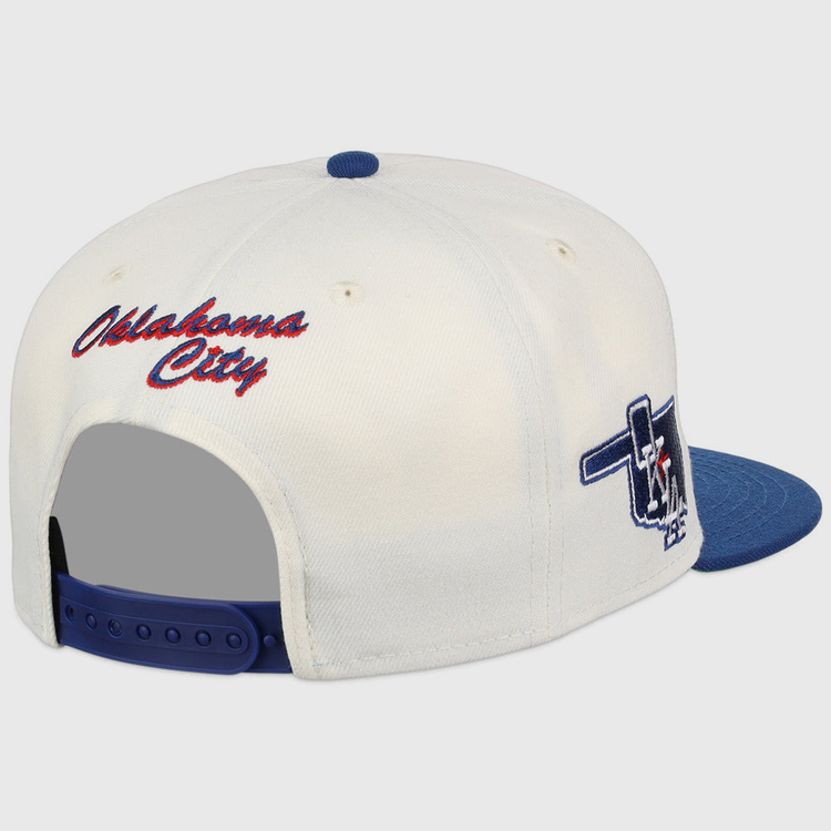 The Ebbets Field Oklahoma City Dodgers MiLB Snapback Ballcap features a white and blue design, red 