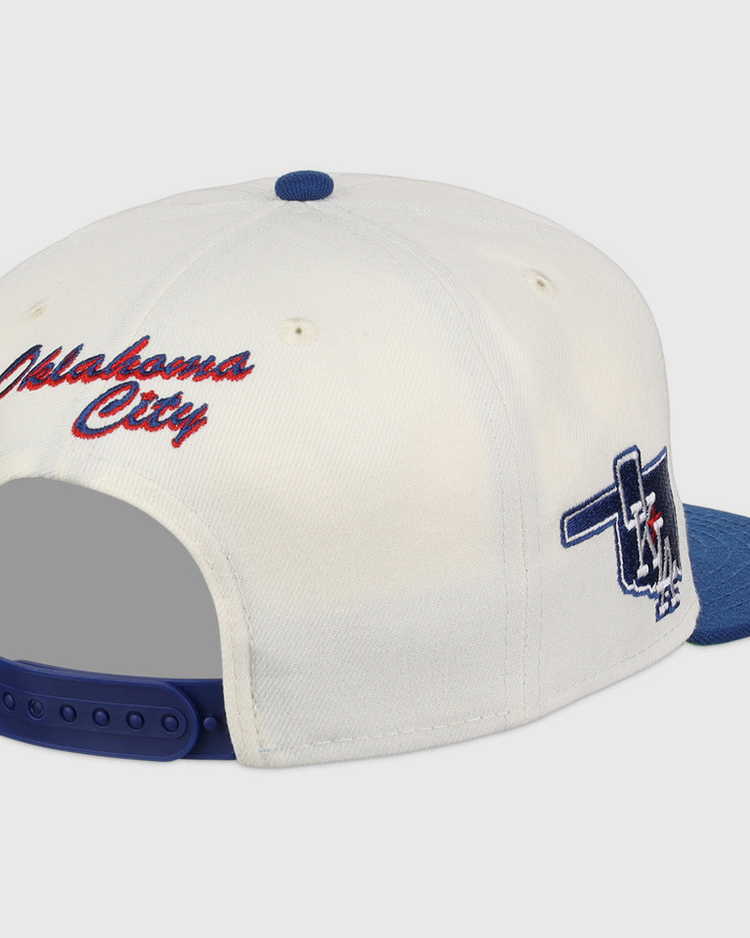 The Ebbets Field Oklahoma City Dodgers MiLB Snapback Ballcap features a white and blue design, red 