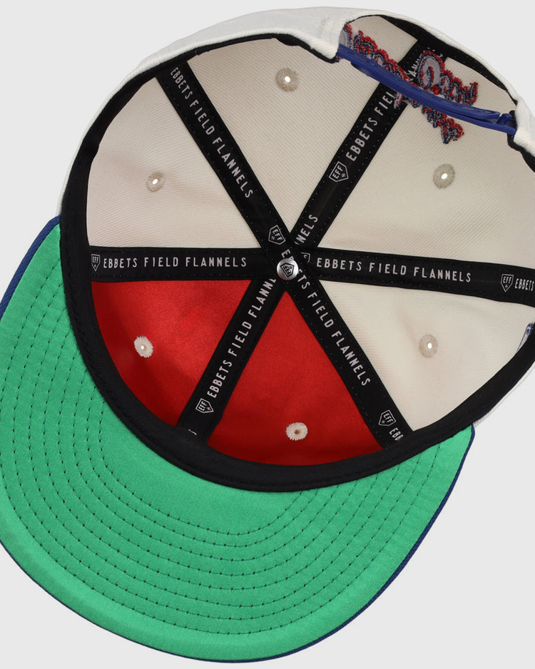 Inside view of the Oklahoma City Dodgers MiLB Snapback Ballcap by Ebbets Field, showing black branded lining, red and white interior panels, white stitched eyelets, and a green underbrim.