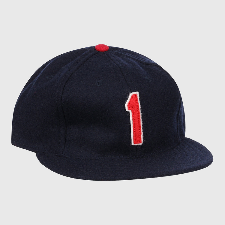 The Ozzie Smith Signature Series Ballcap by Ebbets Field Flannels is a dark blue vintage wool cap, made in the USA, with a red top button and a bold red-and-white number 1 on the front.