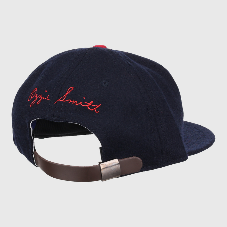 The Ozzie Smith Signature Series Ballcap by Ebbets Field Flannels is a vintage navy wool cap, made in the USA, with a brown adjustable leather strap and Ozzie Smith embroidered in red cursive on the back.