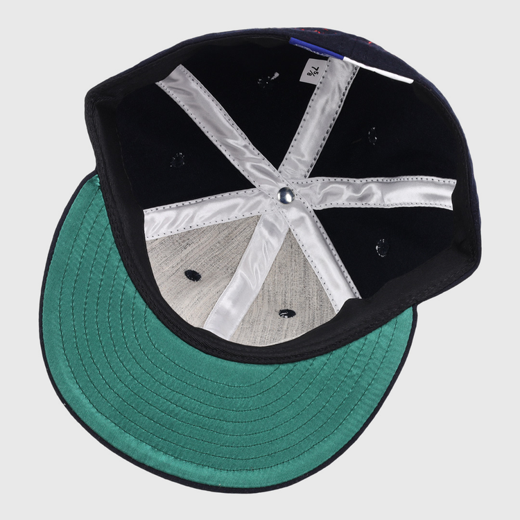 The Ozzie Smith Signature Series Ballcap by Ebbets Field Flannels features a green brim, grey panels, white interior seams, a blue center button, and a size tag—all visible on the USA-made vintage wool cap’s underside.