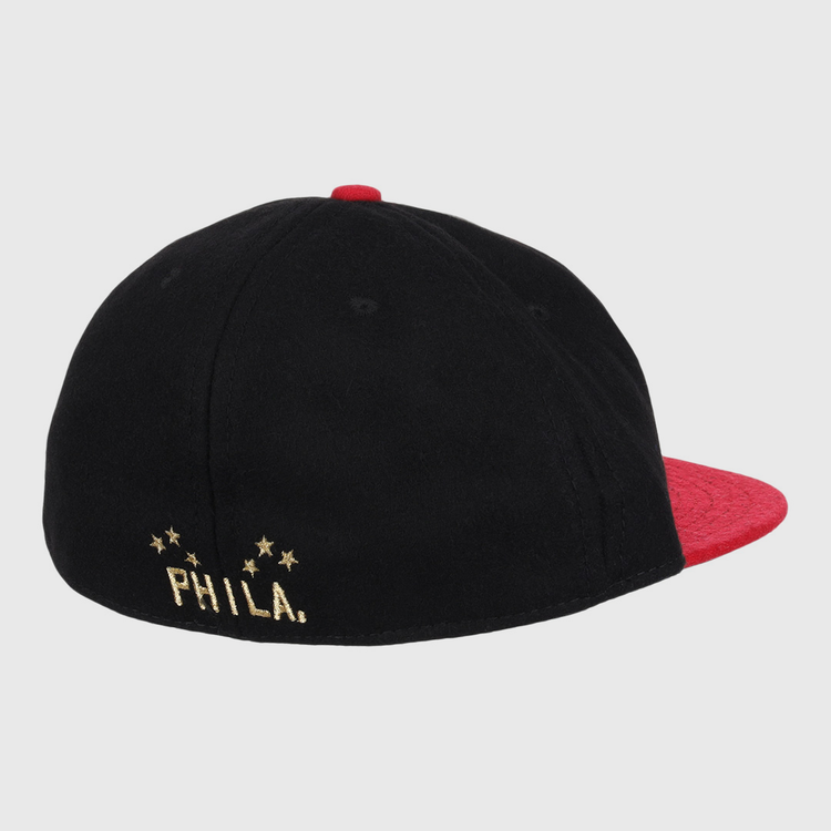 The EFF Philadelphia Stars Gilded Collection Ballcap is a vintage-style black cap with a red brim and top button, PHILA. on the front, and a gold embroidered logo with four stars on the back honoring the Negro National League.