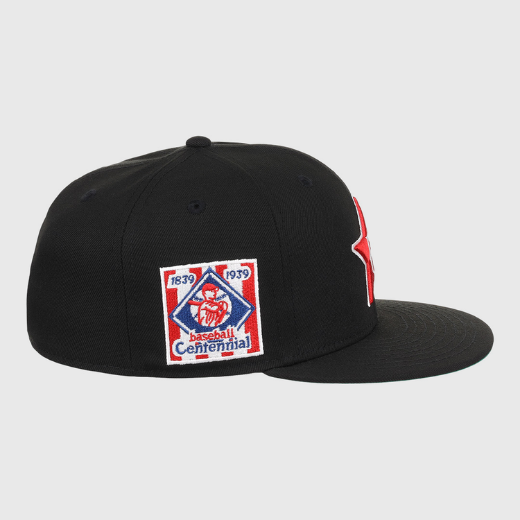 The EFF Philadelphia Stars NLB Team Color Fitted Ballcap is a black flat-brim cap with an embroidered Star logo, plus a side patch reading 1839 1939 Baseball Centennial with a red baseball figure, honoring the Negro National League.
