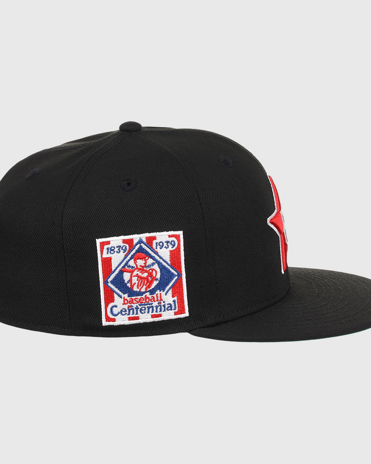 The EFF Philadelphia Stars NLB Team Color Fitted Ballcap is a black flat-brim cap with an embroidered Star logo, plus a side patch reading 1839 1939 Baseball Centennial with a red baseball figure, honoring the Negro National League.