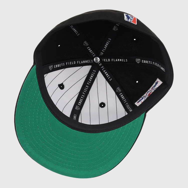 An inside view of the EFF Philadelphia Stars NLB Team Color Fitted Ballcap shows its black design, green undervisor, white pinstripe lining, Ebbets Field Flannels labels on the inner bands, and an embroidered Star logo.