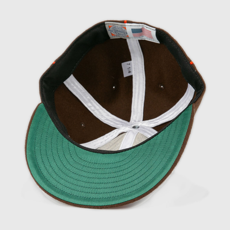 A close-up of the Pocatello Bannocks 1952 Vintage Ballcap by EFF shows its green underside brim, white lining, American flag tag, and a 7 1/4 size label—highlighting the classic wool charm of this retro baseball hat.