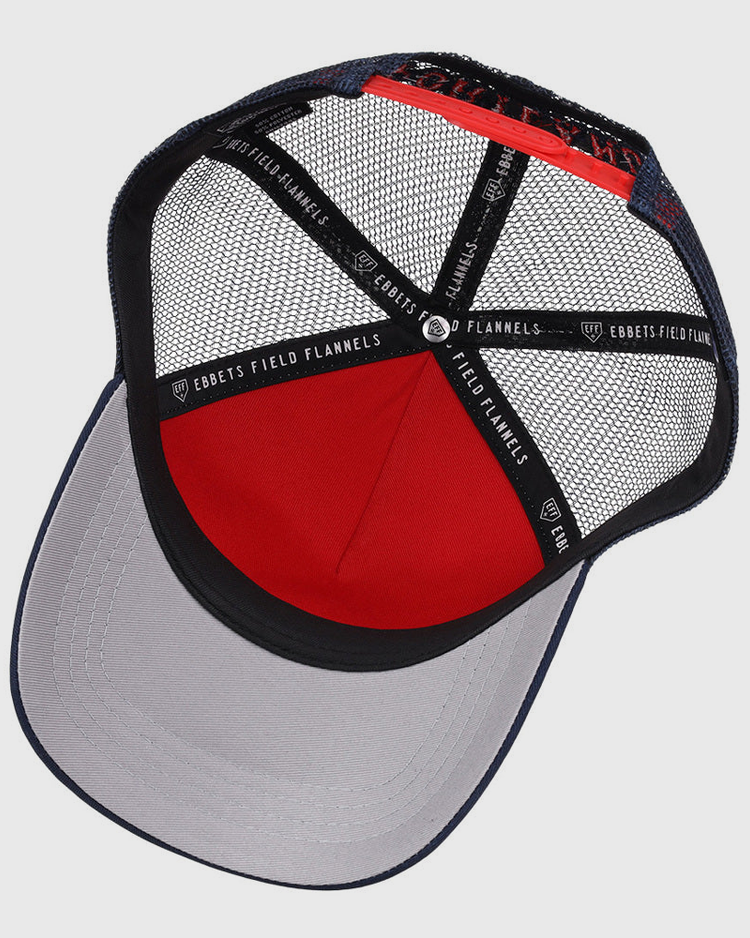 Inside the Portland Sea Dogs MiLB Trucker Ballcap by Ebbets Field, black mesh panels, a red fabric section, a gray brim, and black strips labeled Ebbets Field are visible.