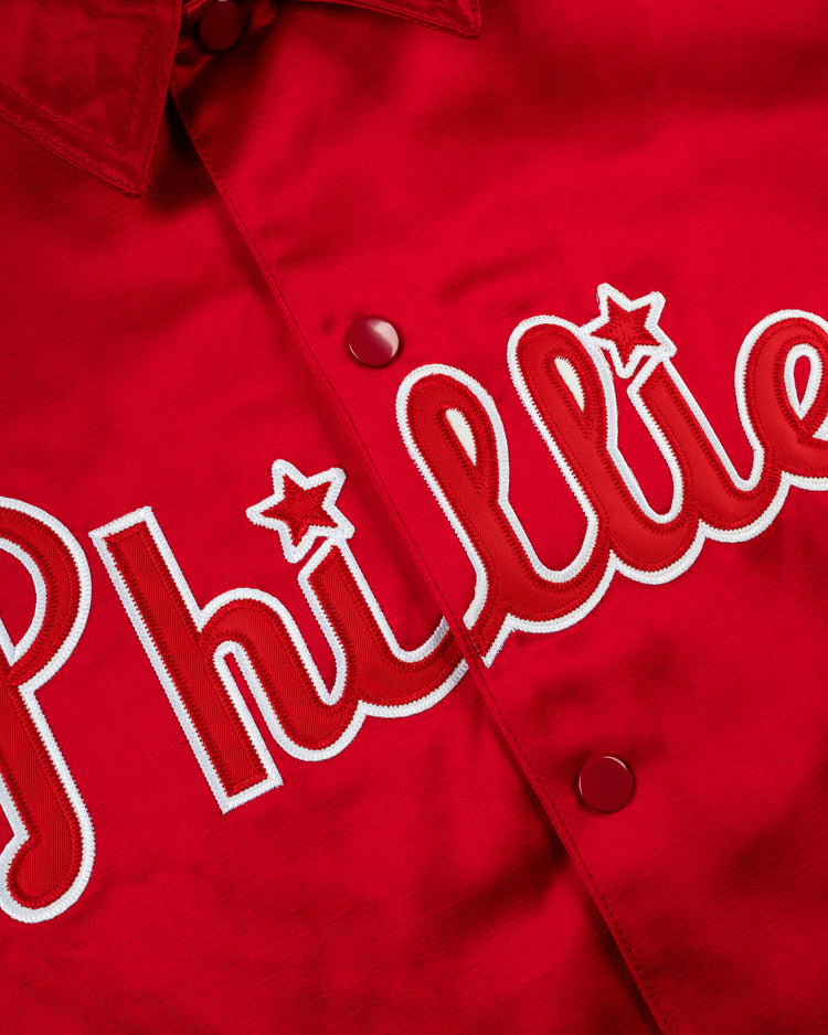 Close-up of the EFF Philadelphia Phillies 1950 Satin Windbreaker Jacket, showcasing white and red embroidered Phillies lettering with star-shaped dots over the is, evoking classic MLB vintage style.