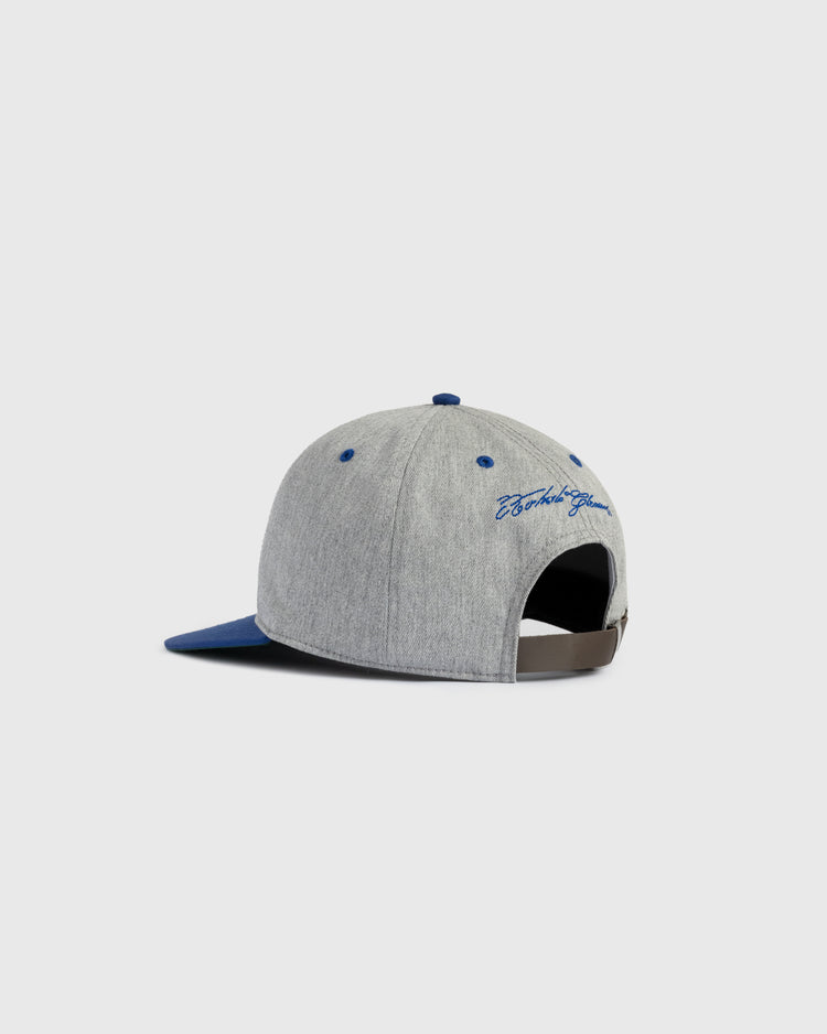 The Puerto Rico 1958 National Team Cotton Twill Ballcap by Ebbets Field features a gray build with blue accents, a blue brim, and an adjustable strap. Beach Squad is embroidered in blue above the back opening, shown on a plain light background.