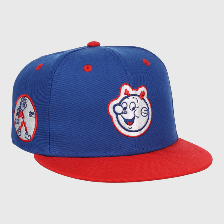 The EFF Reddy Kilowatt EFF DNA Fitted Ballcap features a blue vintage design with a red brim, cartoon bear face front, and side patch of a bear playing baseball—classic style inspired by Ebbets Field Flannels.