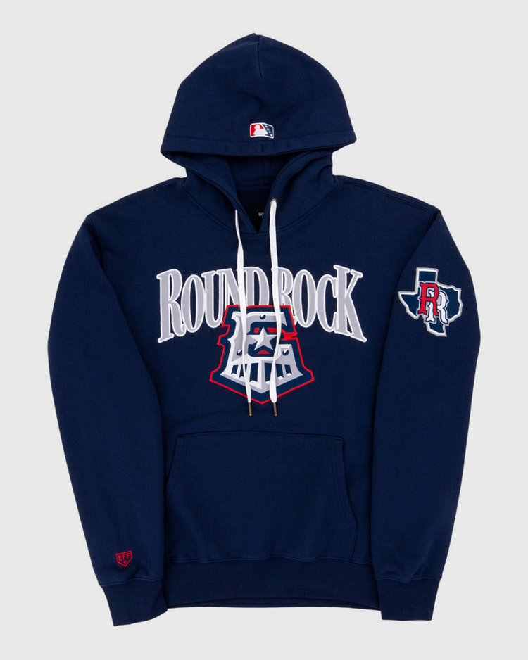 The Ebbets Field Round Rock Express MiLB Cotton Hooded Sweatshirt features navy blue fabric, ROUND ROCK in large white letters on the chest, an emblem below, a left sleeve patch with an R and Texas outline, a front pocket, and white drawstrings.