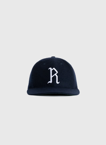 The EFF Richmond Virginians 1961 Authentic Wool Ballcap is a navy vintage cap with a white embroidered R on the front, inspired by the original design and shown against a light gray background.