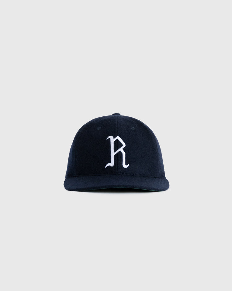 The EFF Richmond Virginians 1961 Authentic Wool Ballcap is a navy vintage cap with a white embroidered R on the front, inspired by the original design and shown against a light gray background.