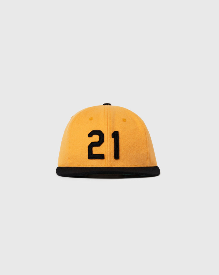 The Ebbets Field Flannels Roberto Clemente 1972 Signature Series Wool Ballcap features yellow wool, a black brim, and the number 21 in black on the front, set against a plain light gray background.