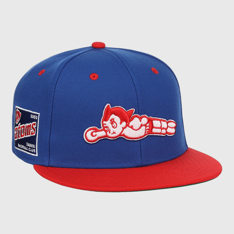 The EFF Sankei Atoms DNA Fitted Ballcap is a blue and red vintage cap with an embroidered Atom Boy flying on the front and a side patch that reads Atoms Baseball Club with the number 4500.