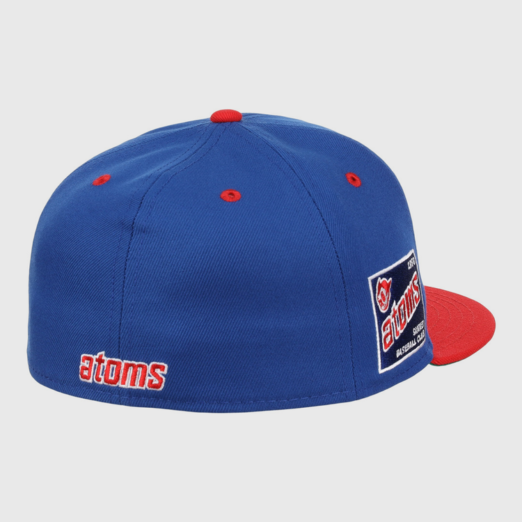 The Sankei Atoms EFF DNA Fitted Ballcap by EFF features blue vintage styling with a red button and brim, atoms embroidered in red and white on the side, an atoms logo patch on the back, and classic Ebbets Field Flannels craftsmanship.