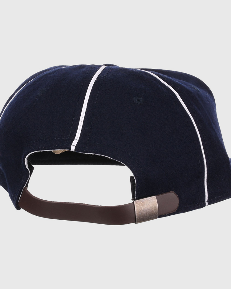 The back of the EFF Santa Cruz Crabs 1908 Vintage Ballcap in navy with white piping features an adjustable brown strap and metal clasp, all crafted from genuine wool baseball cloth.