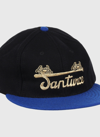 The EFF Santurce Cangrejeros Gilded Collection Ballcap features a black crown, blue brim, gold scroll details, and Santwoz gold script embroidery—a striking nod to the Puerto Rico League.