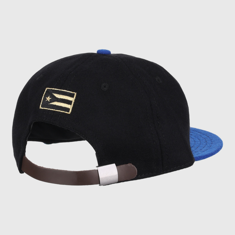 The EFF Santurce Cangrejeros Gilded Collection Ballcap is black with a blue brim, seen from the back. It has an adjustable brown strap and a small gold and white flag detail on the left side, inspired by Puerto Rico League heritage.