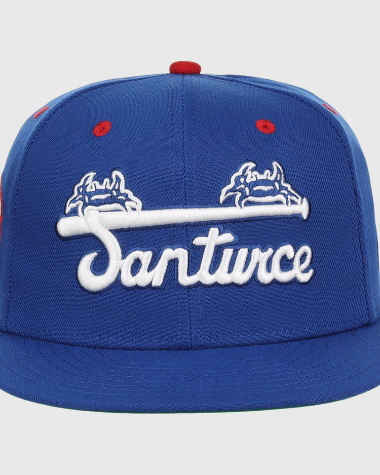 The EFF Santurce Cangrejeros NLB Team Color Fitted Ballcap is a vintage-inspired blue cap with “Santurce” in white script and crab graphics, celebrating the Puerto Rican League legacy.