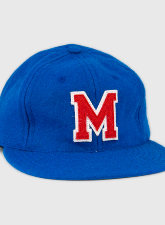 The EFF Southern Methodist University 1962 Vintage Ballcap is a blue wool cap featuring a large red M outlined in white on the front, reminiscent of classic SMU style, displayed against a plain white background.