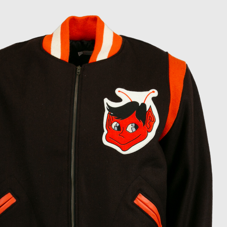 The EFF St. Louis Browns 1952 Authentic Jacket is a vintage wool baseball jacket with orange and white trim, a red cartoon devil patch on the chest, orange shoulder stripe, zip front, and orange-trimmed pockets.