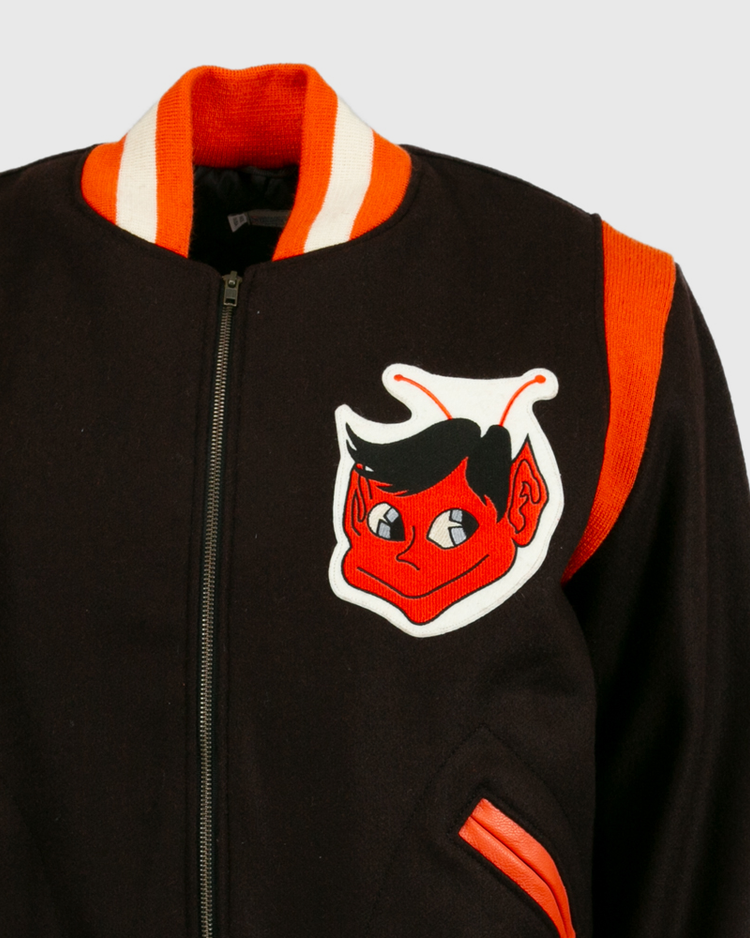 The EFF St. Louis Browns 1952 Authentic Jacket is a vintage wool baseball jacket with orange and white trim, a red cartoon devil patch on the chest, orange shoulder stripe, zip front, and orange-trimmed pockets.