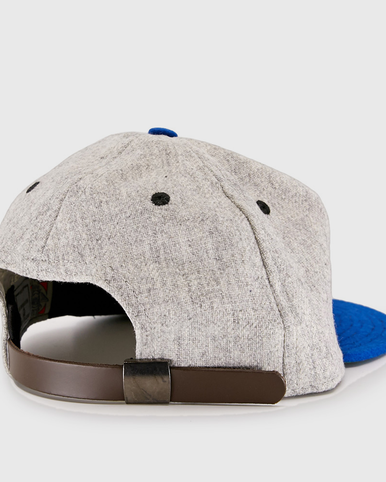 The EFF St. Louis Stars 1929 Vintage Ballcap features a gray crown, blue brim, black eyelets, and a brown adjustable strap with a black buckle, shown from the back and inspired by classic Negro National League style.