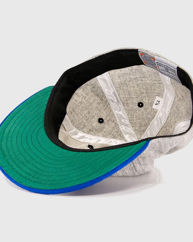 The EFF St. Louis Stars 1929 Vintage Ballcap, inspired by the Negro National League era, features a green and blue brim, black inner band, white stitched lining, and a size tag marked 7 1/4.