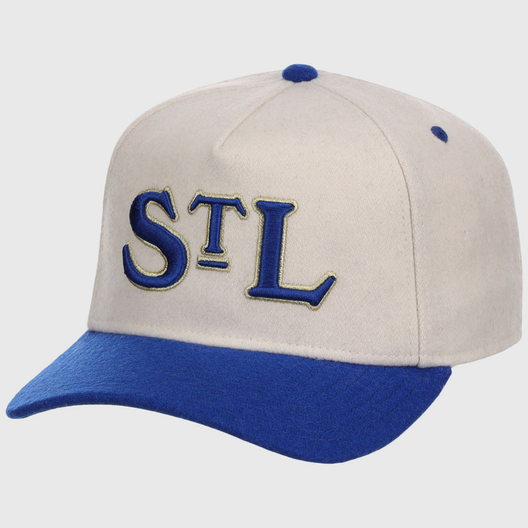 The Ebbets Field St. Louis Stars NLB Ballpark A-Frame Ballcap is beige with a royal blue brim and top button, featuring “STL” embroidered in blue and gold on the front.