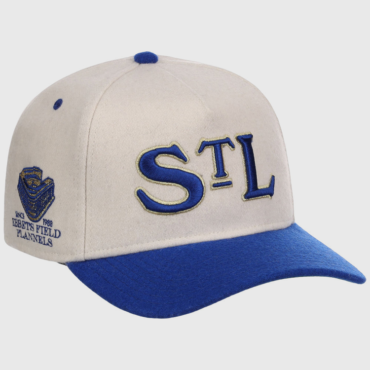 The St. Louis Stars NLB Ballpark A-Frame Ballcap by Ebbets Field features a cream and blue design, STL in blue and gold on the front, a blue bill, and a side patch with Ebbets Field Flannels, stadium logo, and 1988.