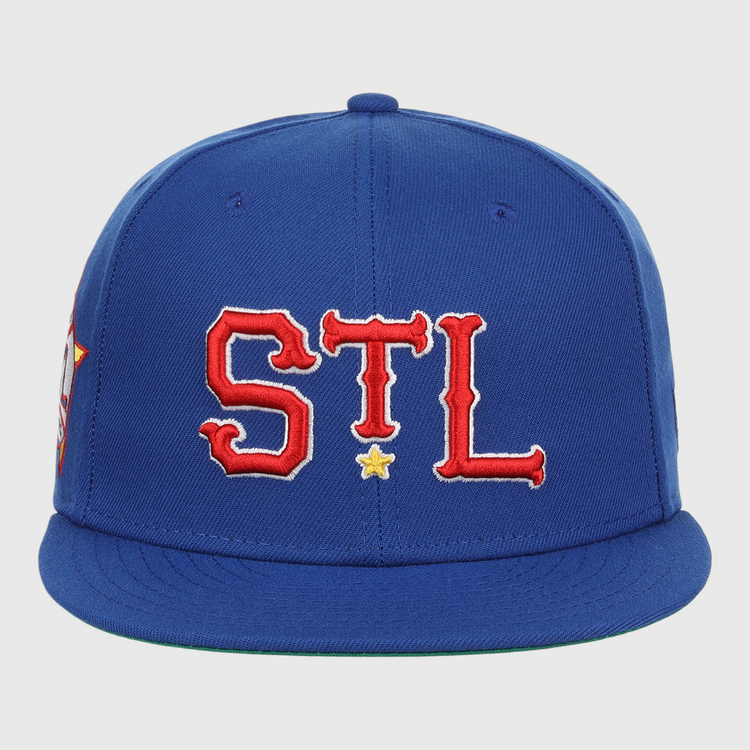 The St. Louis Stars NLB Team Color Fitted Ballcap by EFF features a royal blue design with STL in red and white letters outlined in yellow on the front, plus a small yellow star below, celebrating classic baseball style.