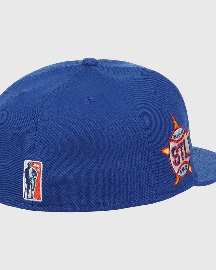 The EFF St. Louis Stars NLB Team Color Fitted Ballcap features a royal blue design with a red, white, and orange side logo and a small player logo on the back, honoring the Negro National League in vintage style.