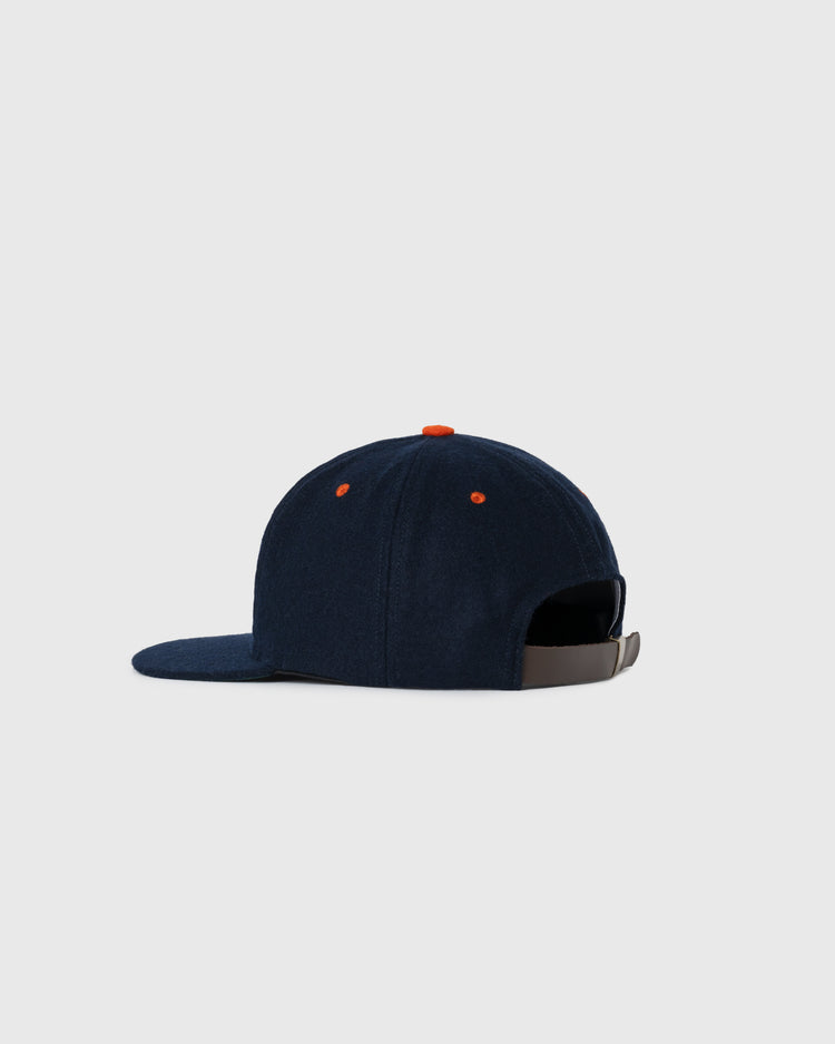 The EFF San Francisco Seals 1940 Authentic Wool Ballcap is shown from the back, featuring a navy wool build, orange top button, and adjustable brown strap, inspired by Pacific Coast League teams and set against a light gray background.
