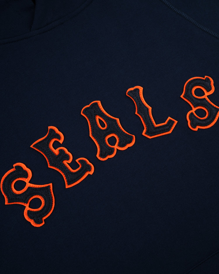 The EFF San Francisco Seals Cotton French Terry Pullover Hoodie features navy blue fabric with large, ornate orange SEALS embroidery inspired by the classic Pacific Coast League team.
