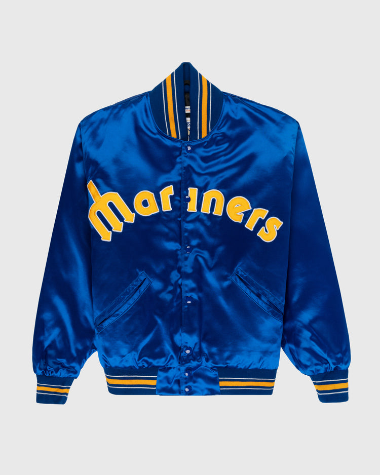 The EFF Seattle Mariners 1982 Authentic All Satin Varsity Jacket features bright royal blue satin, yellow Mariners text, striped blue/yellow ribbed trim, and snap button closure—a true 1982 Seattle Mariners classic reproduction.