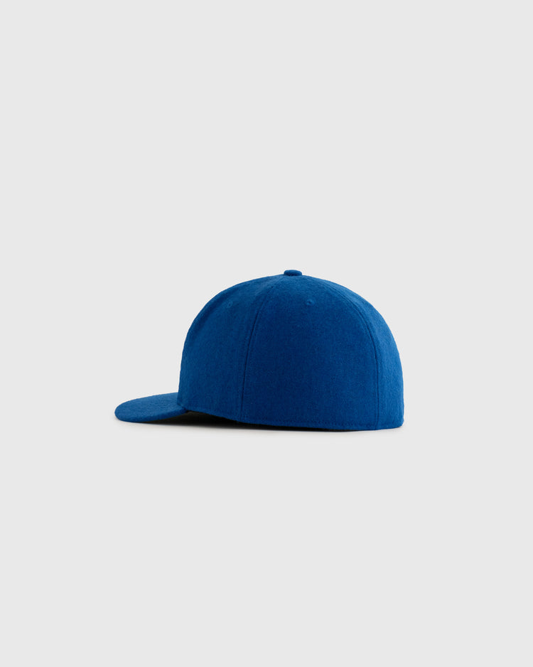 The EFF St. Paul Saints 1955 Authentic Wool Ballcap is shown in blue, displayed from the side against a plain light gray background, capturing the original 1955 design.