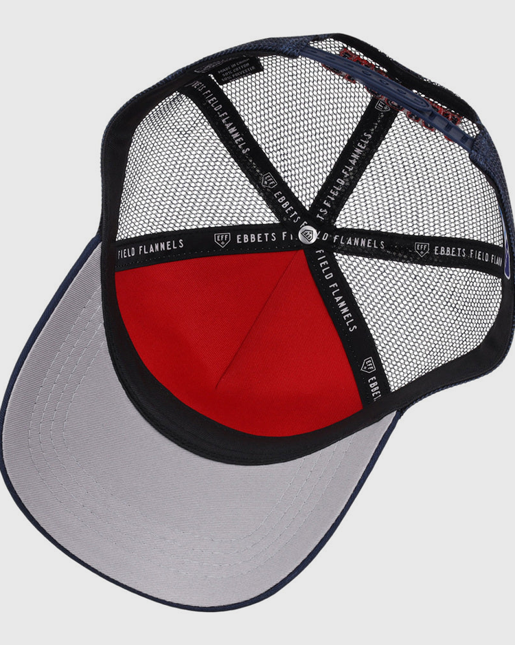 A look inside the Tacoma Rainers MiLB Trucker Ballcap by Ebbets Field shows a gray brim, red front panel, black mesh back, and black inner bands marked Ebbets Field.