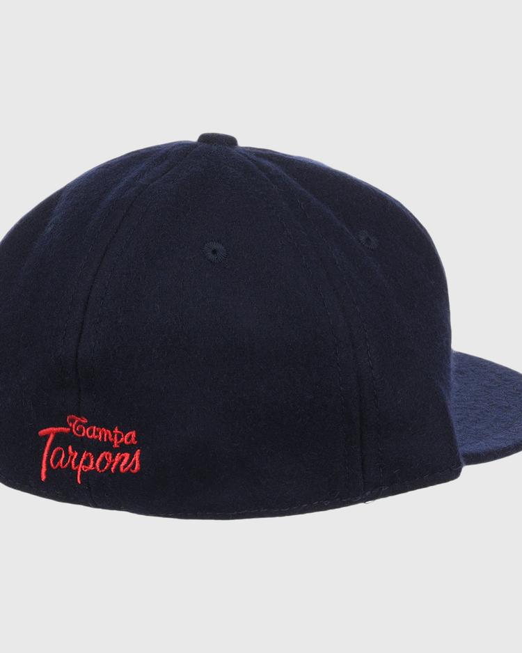 The EFF Tampa Tarpons Letterhead Wool Vintage Ballcap, in navy, features “Tampa Tarpons” embroidered in red script on the back left. The Minor League cap is shown from the back right against a white background.