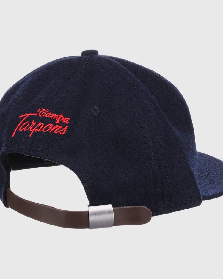 The EFF Tampa Tarpons Letterhead Wool Vintage Ballcap is a navy blue cap with red Tampa Tarpons embroidery on the back and an adjustable brown leather strap with silver buckle, perfect for Minor League baseball fans.