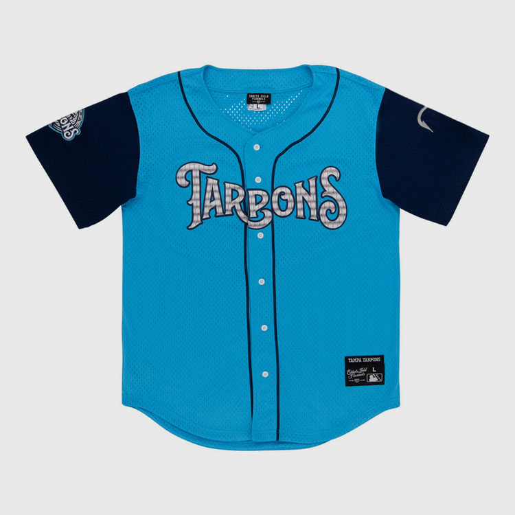 The Ebbets Field Tampa Tarpoons MiLB Button Down Jersey is light blue with 