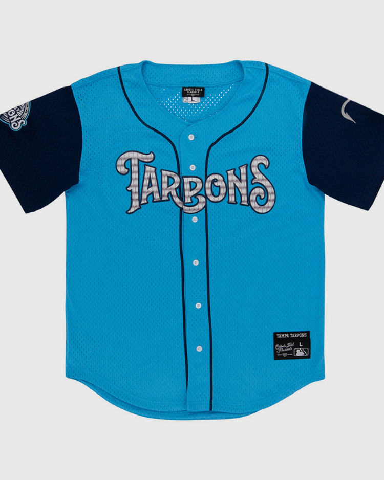 The Ebbets Field Tampa Tarpoons MiLB Button Down Jersey is light blue with 