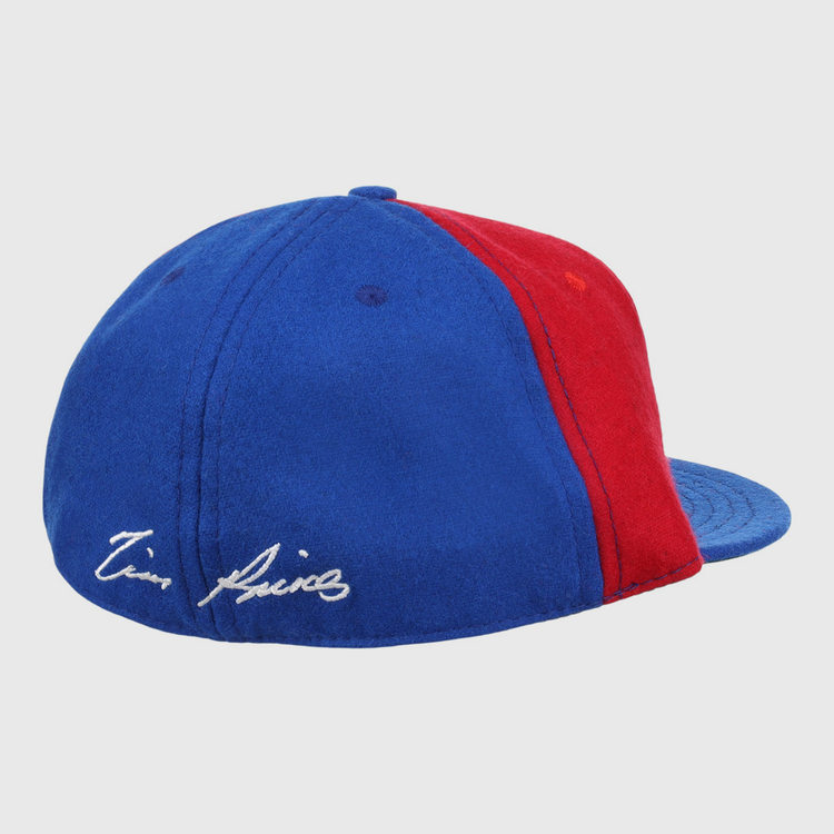 The Ebbets Field Flannels Tim Raines Signature Series Ballcap is a vintage wool cap in blue and red, with two panels of each color and a white Tim Raines signature embroidered on the blue section near the back.