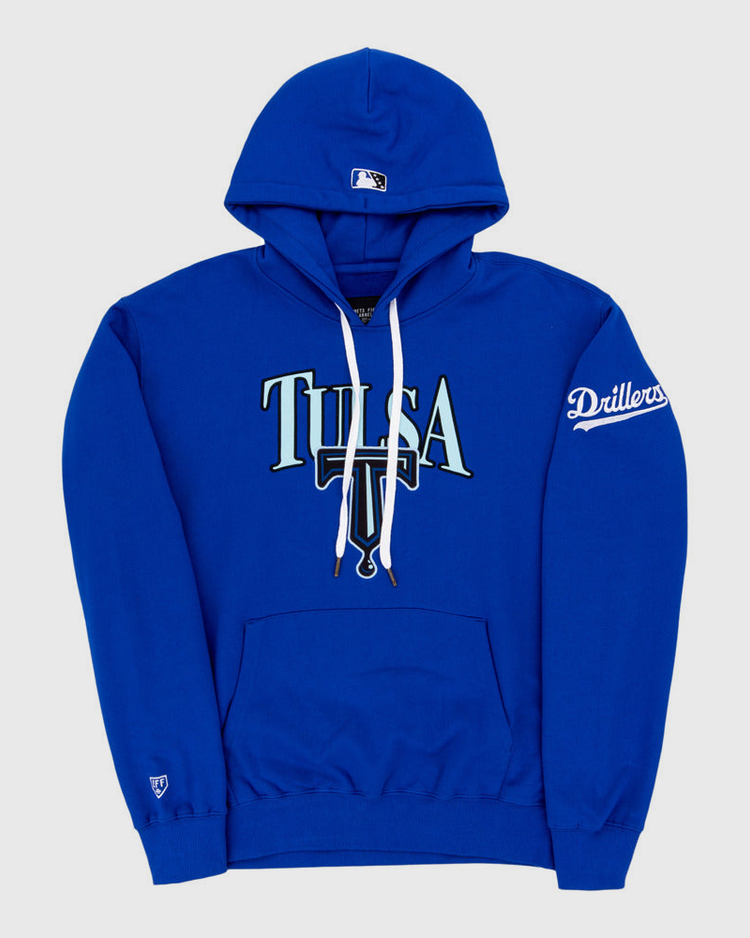 The Ebbets Field Tulsa Drillers MiLB Cotton Hooded Sweatshirt is royal blue with TULSA on the front, a small baseball cap logo on the hood, Drillers on the sleeve, and a front pocket.