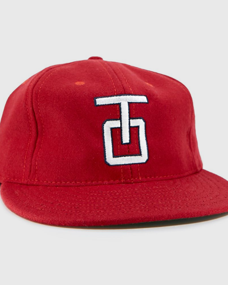 The EFF Tulsa Oilers 1966 Vintage Ballcap is a red wool cap with a flat brim and a white and blue embroidered TG logo on the front.