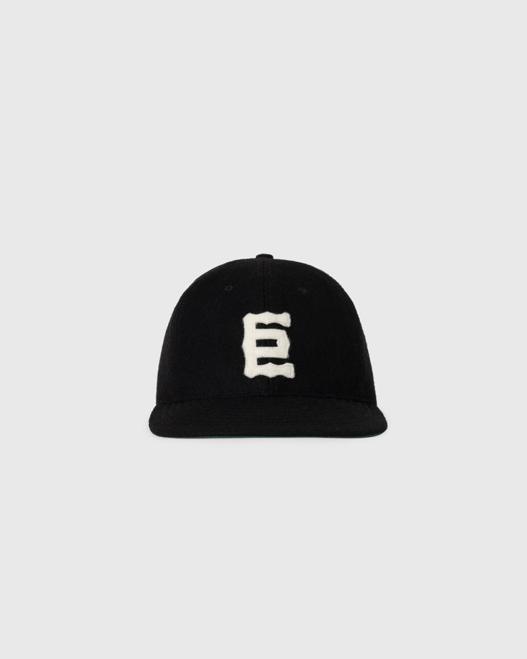 The Ebbets Field NEW - Tokyo Kyojin (Giants) 1940 Vintage Ballcap features a white, stylized E on the front and is shown against a plain light gray background.