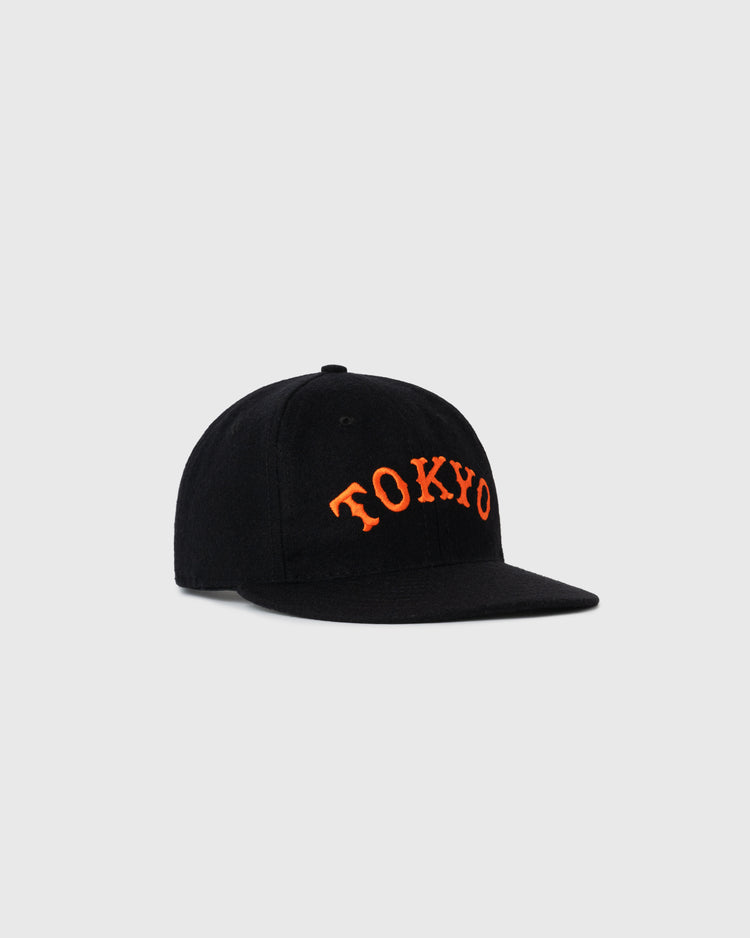 The EFF Tokyo Kyojin (Giants) City Series Wool Ballcap, a black cap with bold orange TOKYO embroidery on the front, is displayed on a plain light gray background.