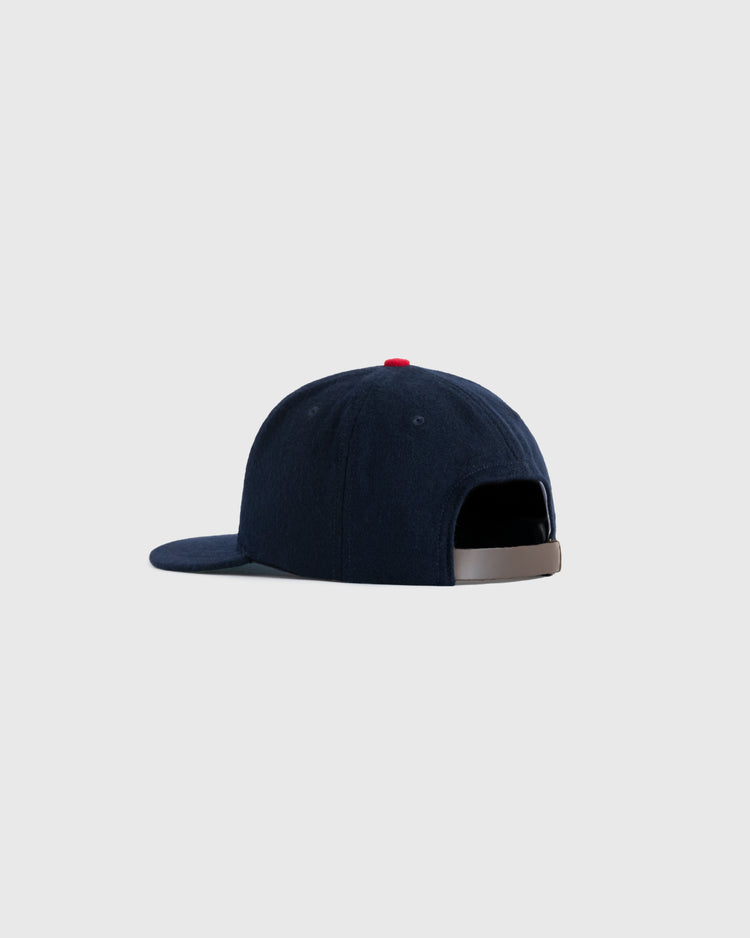 The EFF US Tour Of Japan 1934 Authentic Wool Ballcap is shown from the back with a curved brim, small red top button, and adjustable strap with metal clasp, set against a light gray background.