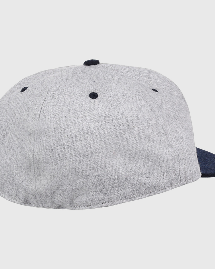 An officially licensed EFF University of Nevada Wolf Pack Mascot Collegiate Wool Ballcap with a gray crown, dark blue brim and button, back and side view, features ventilation eyelets on top—perfect for vintage fans.
